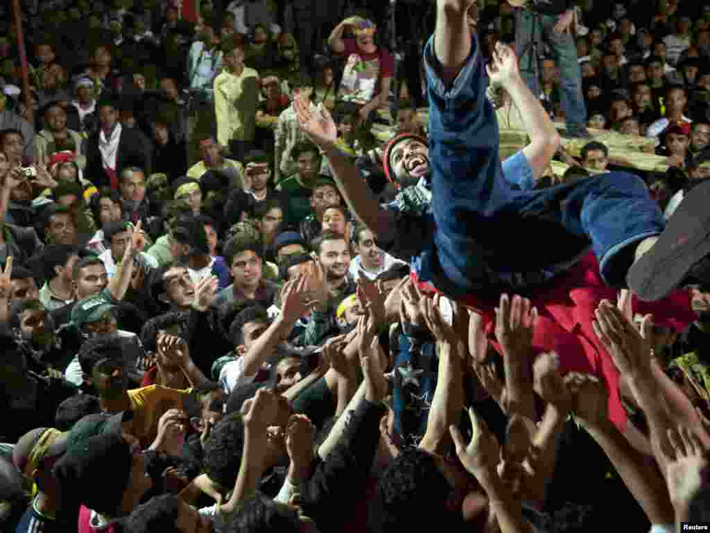 Antigovernment demonstrators in Bahrain throw into the air a prisoner pardoned by the king. Photo by James Lawler Duggan for Reuters