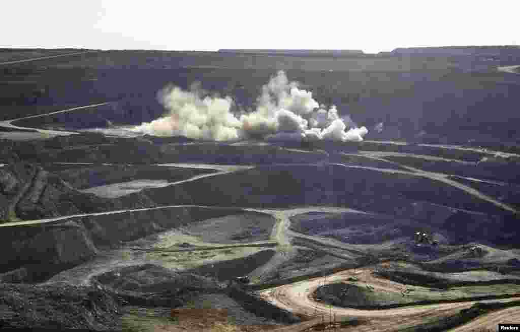 Controlled explosions raise dust inside Altyntau open pit gold mine outside northern Kazakhstan's town of Kokshetau.