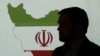 Stuart Davis, a director at one of FireEye's subsidiaries, stands in front of a map of Iran as he speaks to journalists about the techniques of Iranian hacking, in Dubai, September 20, 2017