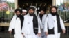 Members of a Taliban delegation, led by chief negotiator Mullah Abdul Ghani Baradar (center, front), leave after peace talks with Afghan senior politicians in Moscow on May 30, 2019. 