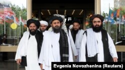 Members of a Taliban delegation, led by chief negotiator Mullah Abdul Ghani Baradar (Center, front), leave after peace talks with Afghan senior politicians in Moscow, Russia May 30, 2019. 