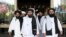 Members of a Taliban delegation, led by chief negotiator Mullah Abdul Ghani Baradar (center), leave after peace talks with Afghan politicians in Moscow in May.
