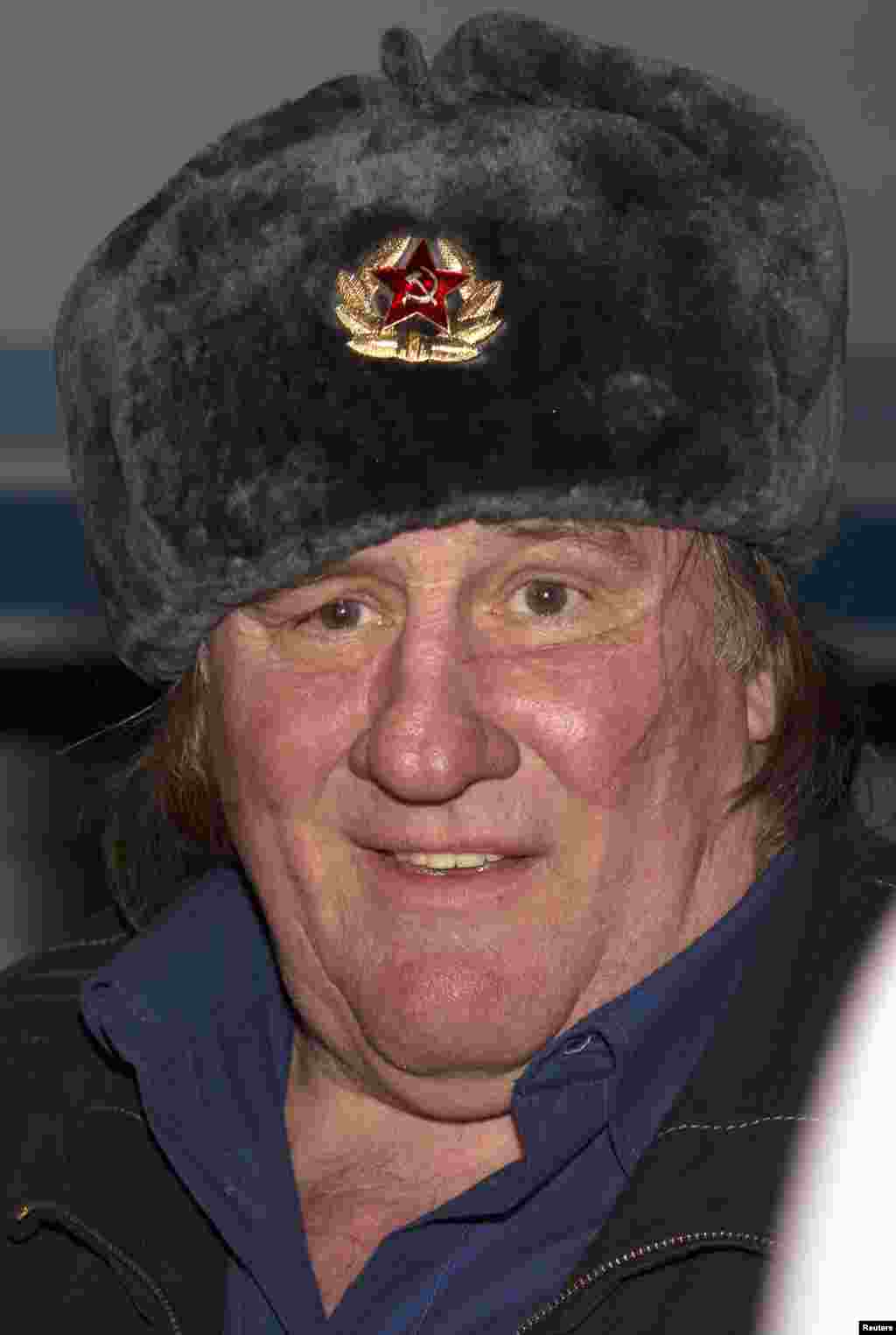 Actor Gerard Depardieu wears a traditional Russian hat, also known as a ushanka, during a welcoming ceremony at the airport in Grozny, Chechnya. The actor says he plans to shoot a movie in the Russian republic. Depardieu was granted a Russian passport by President Vladimir Putin in January after complaining of high tax rates in France. (Reuters/Rasul Yarichev)