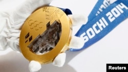 A gold medal manufactured for the 2014 Winter Olympic Games in Sochi is seen on display at a Moscow jewelery factory on June 28.