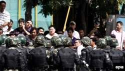 Soldiers try to stop an angry Han Chinese crowd in Urumqi on July 8.