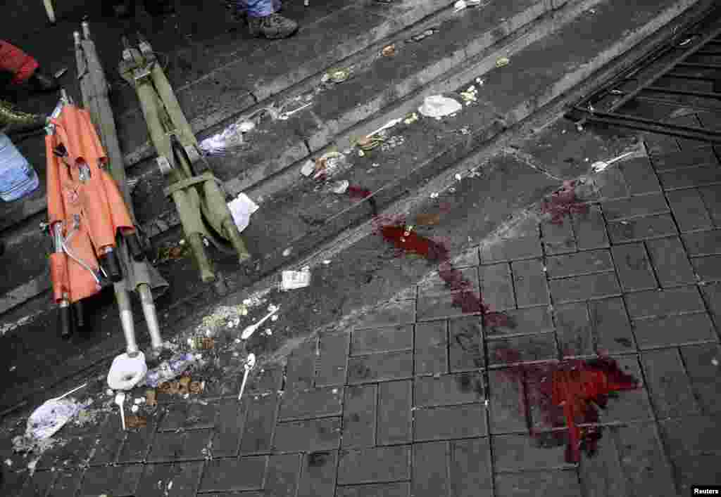 Ukraine -- Blood and stretchers are seen on the pavement during clashes with riot police near Independence Square in Kyiv, February 20, 2014