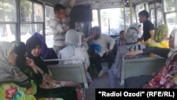 Tajik women wear hijab while riding in a bus. (file photo)