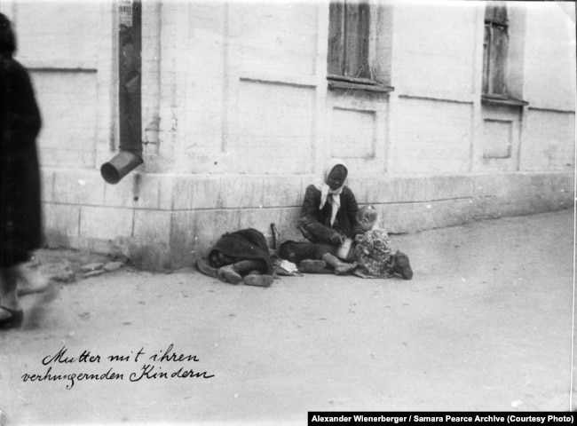 «Мати зі своїми голодними дітьми» (авторський підпис). Харків, 1933 рік. Фото Александра Вінербергера. Надано власником авторських прав Самарою Пірс. Вперше надруковано у книзі «Національна книга пам’яті жертв Голодомору. Харківська область, Харків 2018 рік»
