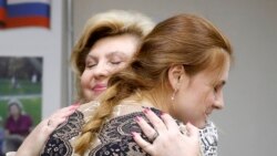 Butina hugs Kremlin-appointed human rights commissioner Tatyana Moskalkova on November 18.