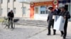 A Kyrgyz election worker carries a ballot box during voting in the town Belovodsk on September 30. 