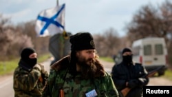 Milutin Malisic, a member of a Serbian Chetnik paramilitary group, and armed members of a local self-defence unit man a checkpoint on the highway between Simferopol and Sevastopol in the Crimean peninsular March 13, 2014