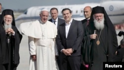Pope Francis arrives on the Greek island of Lesbos on April 16 with Greek Prime Minister Alexis Tsipras (second from right), Greek Archbishop Ieronimos (far right), and Patriarch Bartholomew (left), the spiritual leader of Orthodox Christians.