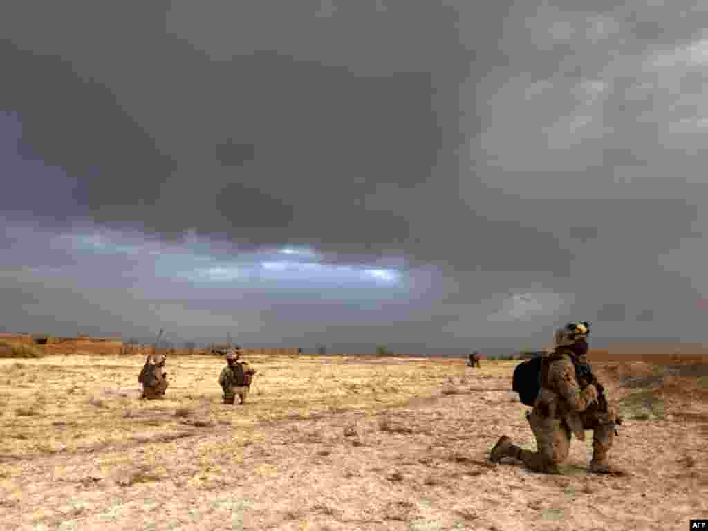 U.S. Marines patrol in Trikh Nawar near Marjah in Afghanistan's southern Helmand Province. - The U.S.-led offensive in southern Afghanistan is progressing at a slower pace than expected due to Taliban resistance and deadly roadside bombs, U.S. defense chiefs have said. Photo by Patrick Baz for AFP