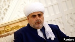 Azerbaijan = Sheikh-ul-Islam Allahshukur Pashazade looks on during a meeting with Pope Francis at the Heydar Mosque in Baku, October 2, 2016.