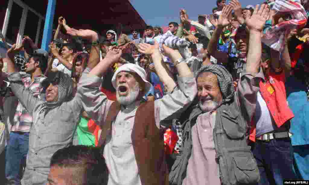 Spectators cheer during the start of the match.