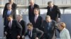 The heads of NATO member states step off the podium where they took a family photo in Strasbourg on April 4.