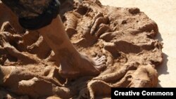 Clay and crushed stone being squished smooth by a barefoot potter in Zlakusa.