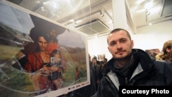 Poturovic stands by his prize-winning shot at the New Temple gallery in Sarajevo.