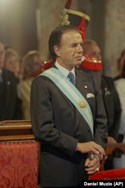 Argentina's President Carlos Menem wearing a presidential sash while attending Te Deum in Buenos Aires, Argentina, July 9, 1996.