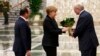 Belarusian President Alyaksandr Lukashenka (right) welcomes German Chancellor Angela Merkel and French President Francois Hollande in Minsk on February 11 for the first day of the Minsk II talks.