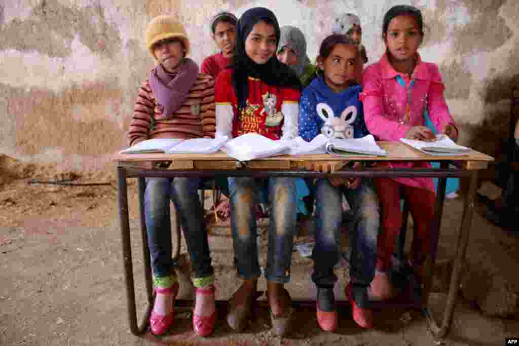 Syrian children sit during a class in a barn that was converted into a makeshift school to teach internally displaced children in a rebel-held area of Daraa, in southern Syria, on November 10. Rebels hold most of Daraa Province, but the regional capital is largely controlled by the government. (AFP/Mohamad Abazeed)