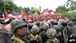 Supporters of former Prime Minister Thaksin Shinawatra face off with Thai soldiers on April 10