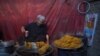 An Afghan worker prepares sweets at a traditional factory ahead of the holy month of Ramadan at the Chendawol market in Kabul. (AFP/Wakil Kohsar)