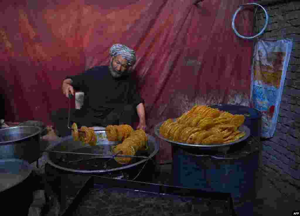 An Afghan worker prepares sweets at a traditional factory ahead of the holy month of Ramadan at the Chendawol market in Kabul. (AFP/Wakil Kohsar)