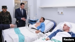 Syrian President Bashar al-Assad visits troops at a military hospital in Damascus on January 31 who were injured in clashes with rebels.