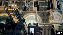 Firefighters rescue employees and guests of the Taj Mahal Hotel in downtown Mumbai, one of the scenes of the shootouts with gunmen in the November 2008 attacks.