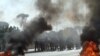 Lebanese soldiers stand guard as supporters of the Future Movement burn tires during a demonstration in support of Saad Hariri in Beirut on January 25.