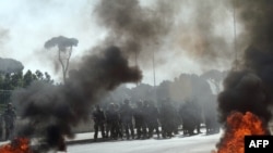 Lebanese soldiers stand guard as supporters of the Future Movement burn tires during a demonstration in support of Saad Hariri in Beirut on January 25.