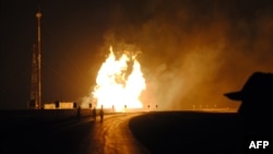 FILE: The aftermath of a bomb attack on a gas pipeline in southwestern Pakistan.