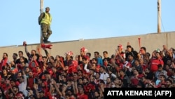 Fans cheer at the AFC Champions League football match at Azadi Stadium in Tehran on October 23, 2018.