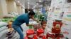 A shop worker arranges the cans of Iranian tomato paste at a super market in the city of Najaf, Iraq October 7, 2018. Picture taken October 7, 2018. REUTERS/Alaa Al-Marjani