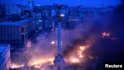 Smoke rises above Independence Square during anti-government protests in central Kyiv in February 2014. 