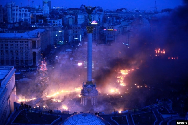 Smoke rises above Independence Square during anti-government protests in central Kyiv in the early hours of February 19, 2014.