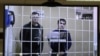 Two of the defendants, Vladimir Kalmykov (left) and Ishtimir Khudzhamov, take part in a virtual court hearing in Moscow. (file photo)