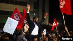 Ennahda supporters celebrate outside the group's headquarters in Tunis on October 25.