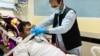 A patient who is infected with COVID-19 receives medical care at a hospital in Kabul on June 1.