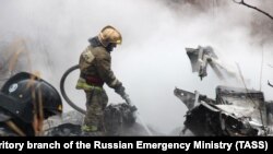 A firefighter works at the site of a helicopter crash in Khabarovsk on April 11.