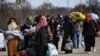 Migrants carry their belongings in Edirne on March 4, 2020