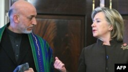 U.S. Secretary of State Hillary Clinton (right) with Afghan President Hamid Karzai in Washington in May