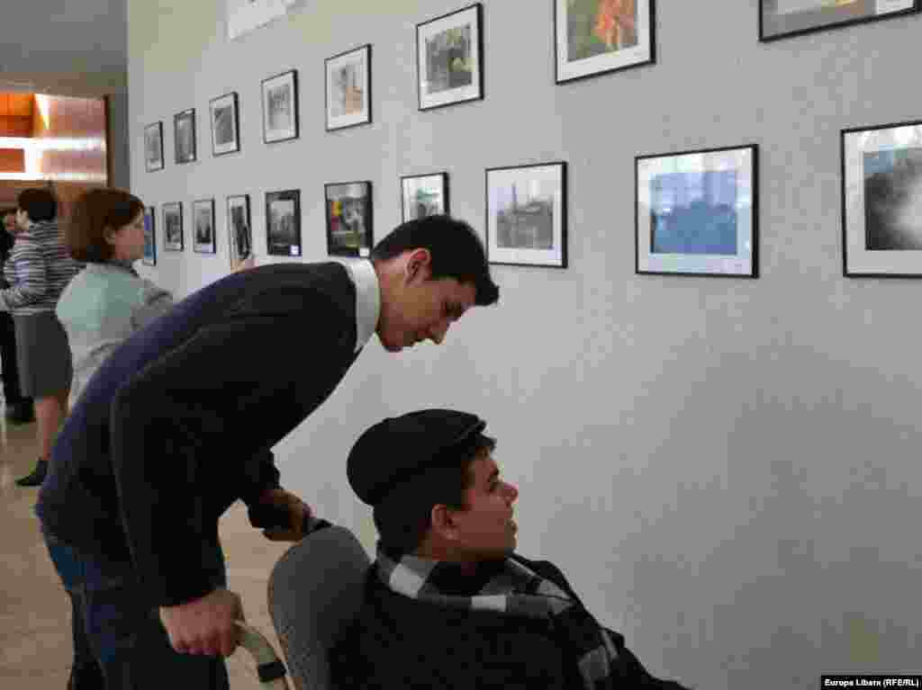 Tânărul fotograf Ion Radu îşi admira lucrarile puse in rama