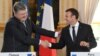 French President Emmanuel Macron (right) shakes hands with his Ukrainian counterpart, Petro Poroshenko, during a joint press conference after a meeting at the Elysee Palace in Paris on June 26.