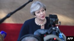 British Prime Minister Theresa May speaks to reporters at European Council headquarters ahead of the EU summit in Brussels on June 22.