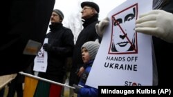 Demonstrators gather outside the Russian Embassy in Vilnius, Lithuania, to protest against Russian intervention in Ukraine in March 2014.