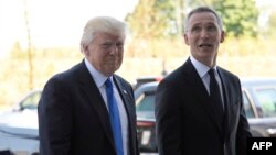 NATO Secretary-General Jens Stoltenberg (right) welcomes U.S. President Donald Trump upon his arrival for the NATO summit in Brussels on May 25.