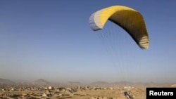 Afghan paraglider Zakia Mohammadi flies in Kabul on September 14.