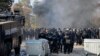 Bulgarian riot police stand by during clashes in the migrant reception center at Harmanli on November 24 after 1,500 migrants started rioting and setting fires at the country's largest refugee camp. 